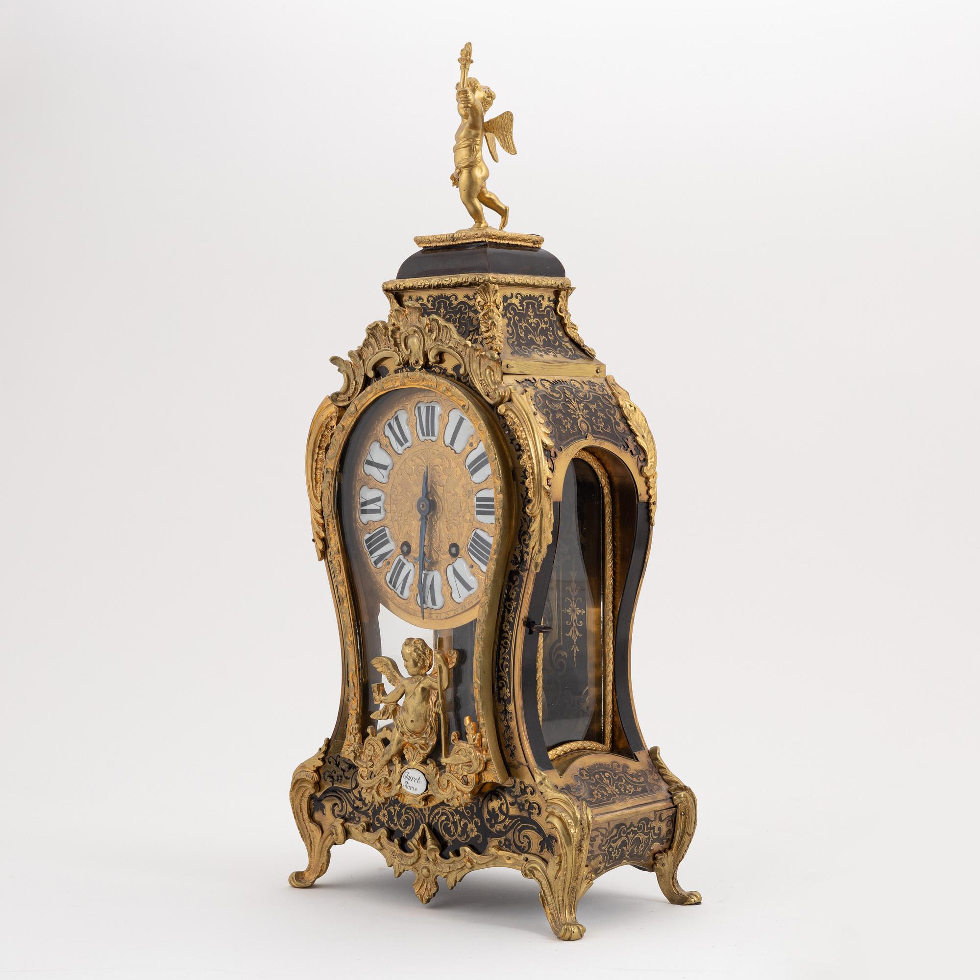 A 19th century rococo style clock, and a 18th century rococo console.