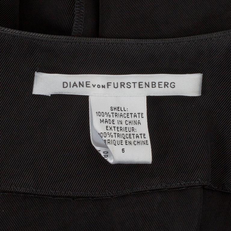 DIANE VON FURSTENBERG, a black wrap dress. Size US 6.