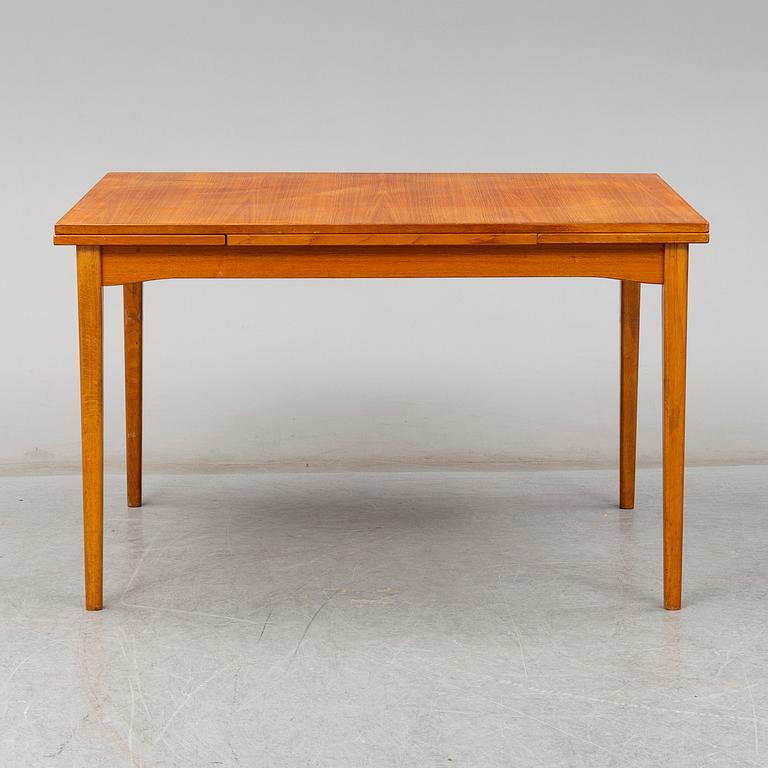 A second half of the 20th century teak veneered dining table.