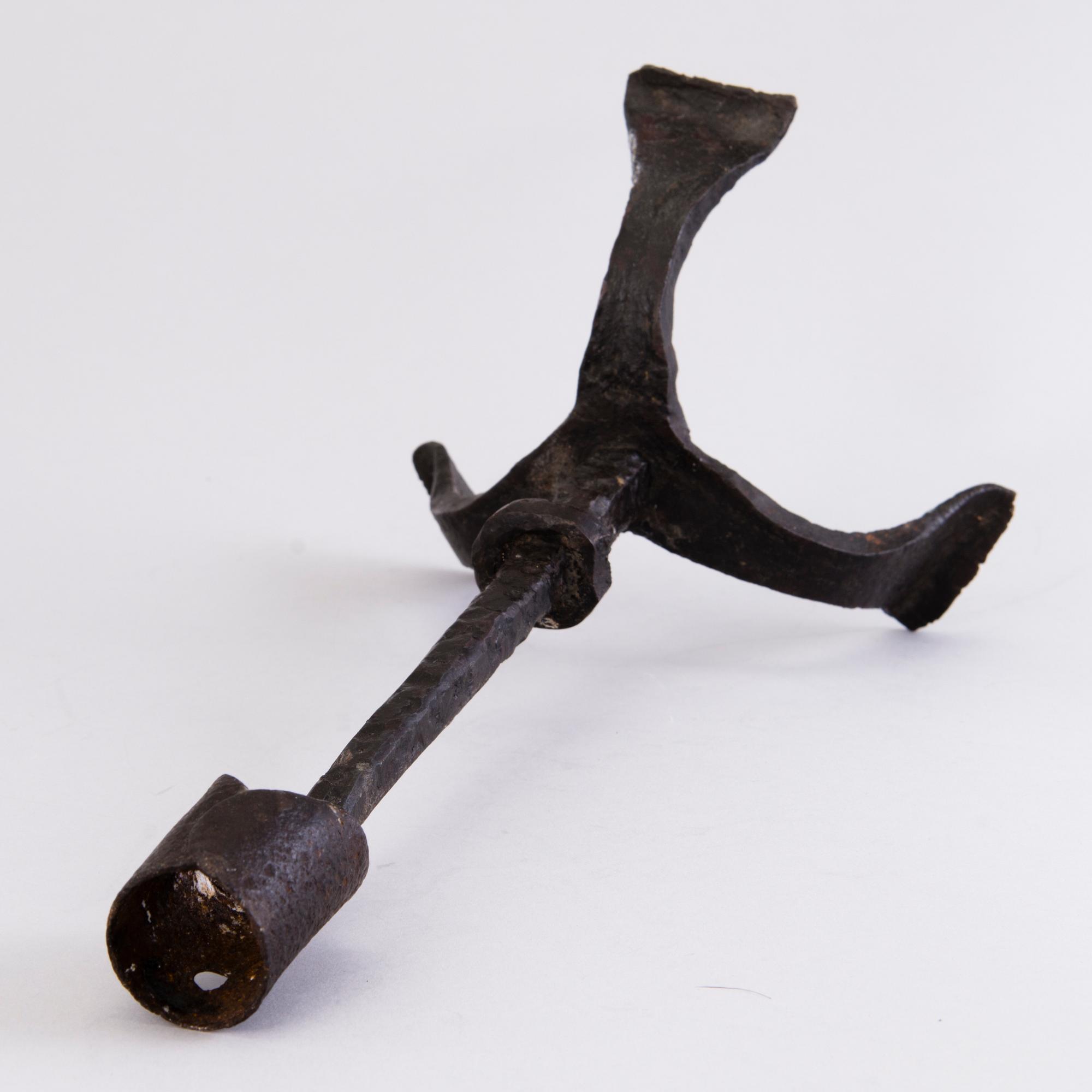 A CANDLESTICK, iron, 18th century or older.