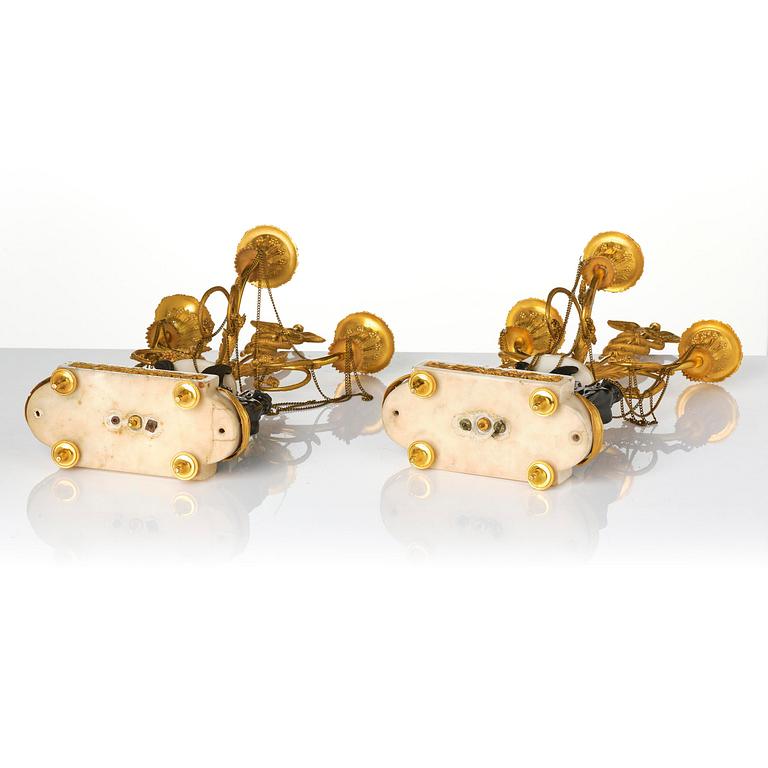A pair of Louis XVI three lights Candelabra, Parisian works, in the manner of François Rémond, late 18th century.