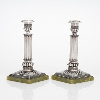 A pair of silver candlesticks, maker's mark A.T., Saint Petersburg 1908-26.