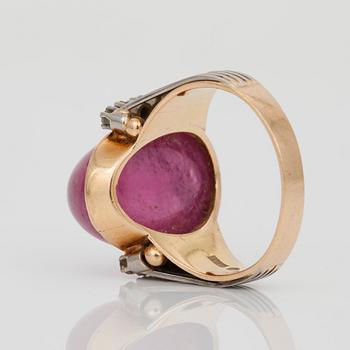 A cabochon-cut tourmaline and brilliant-cut diamond ring.