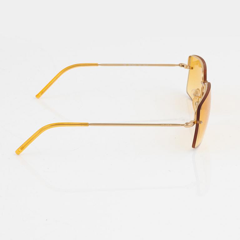 Gucci, a pair of gold and orange-toned glasses.