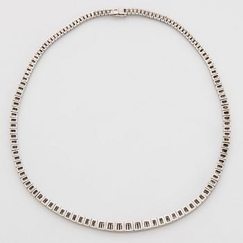 A platinum necklace set with tapered baguette-cut diamonds.