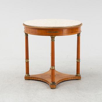 A table with marble top and brass mountings from around year 1900.