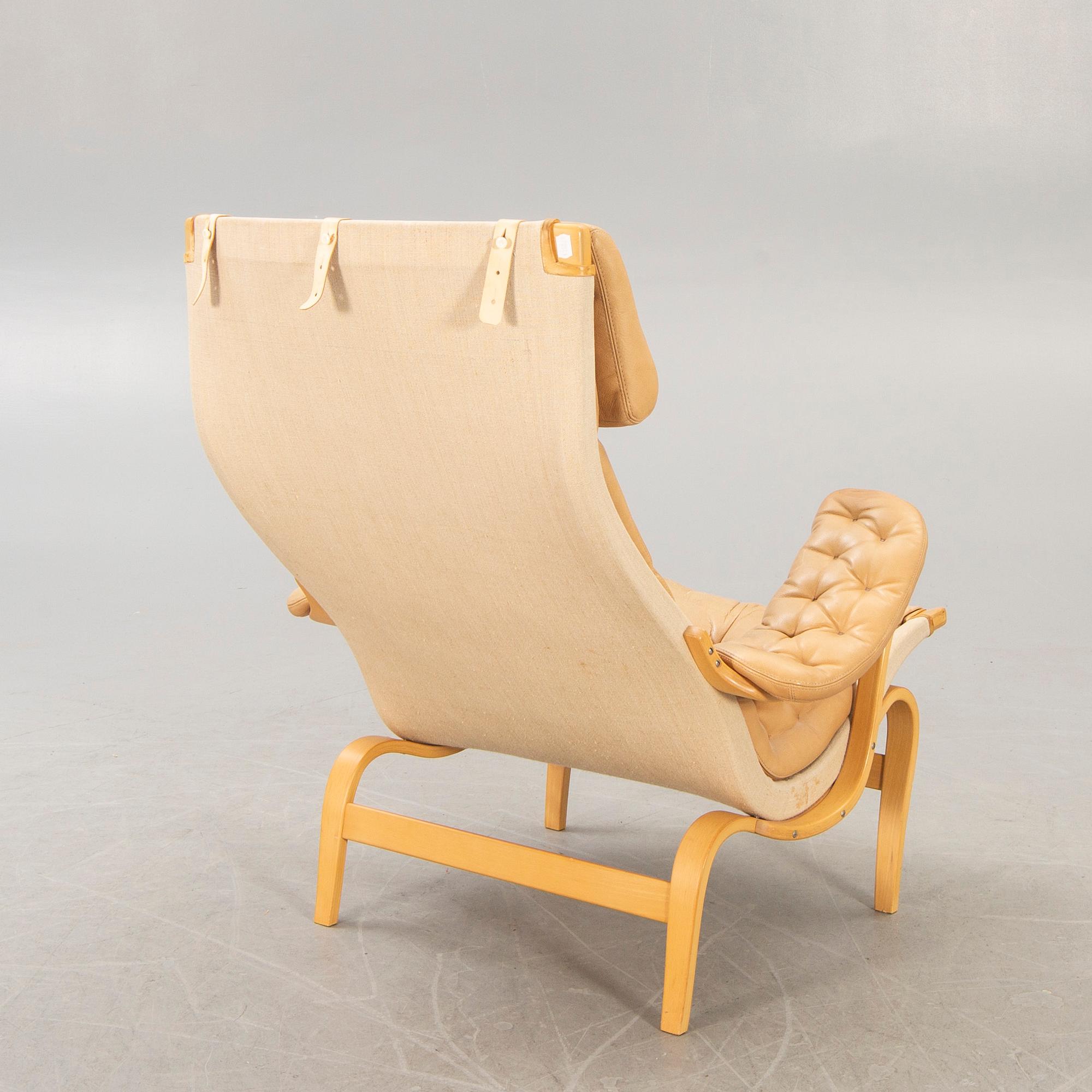 A Bruno Mathsson "Pernilla" leather easy chair for DUX later part of the 20th century.