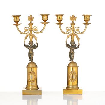 A pair of Empire gilt-brass two-branch candelabra, Stockholm, early 19th century.