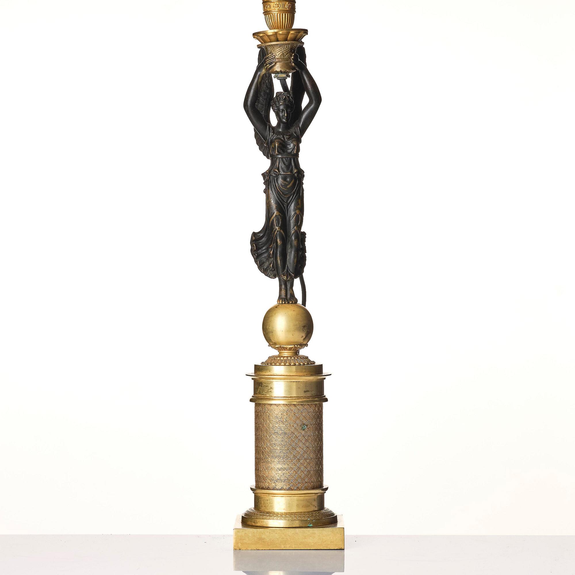 A French Empire ormolu and patinated bronze table lamp, early 19th century.