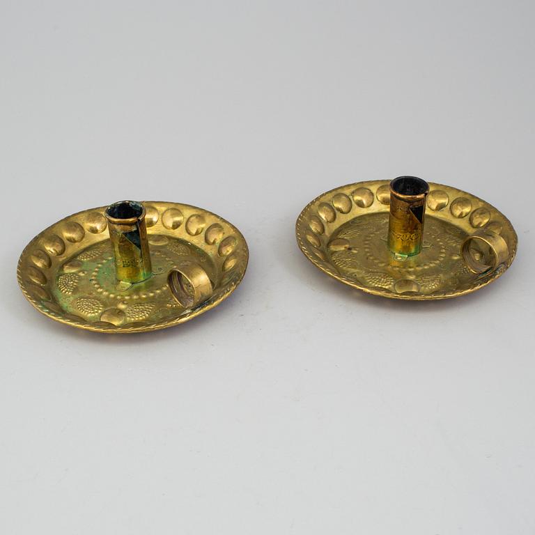 A pair of brass baroque style candlesticks.