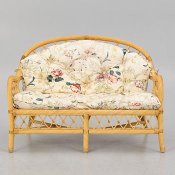 A rattan sofa and two armchairs, later part of the 20th century.