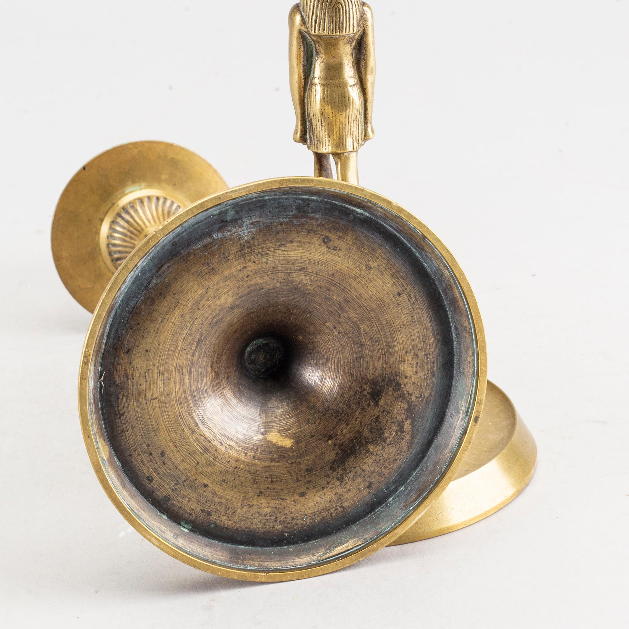 A pair of early 20th century brass candle sticks.