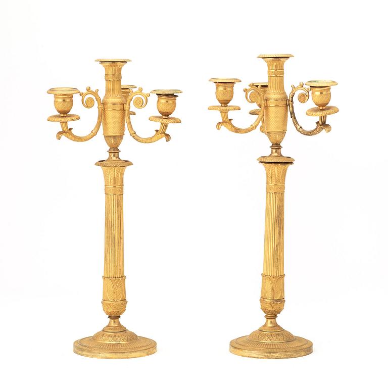 A pair of French Empire early 19th century gilt bronze four-light candelabra.