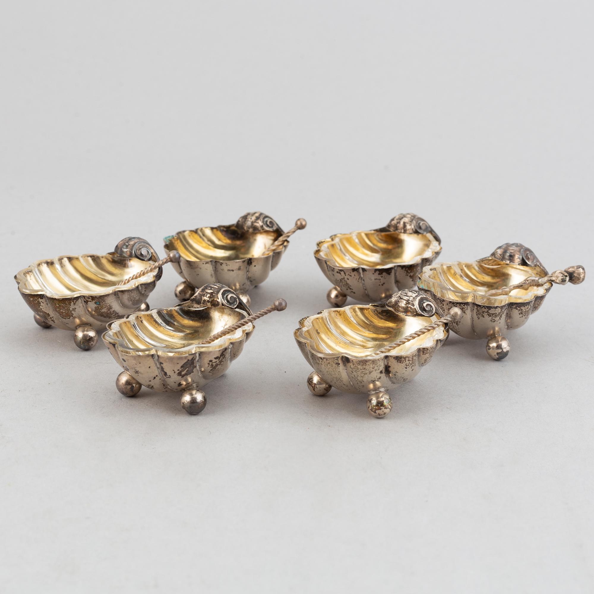 A set of six German parcel-gilt silver 800 salt cellars in fitted case.