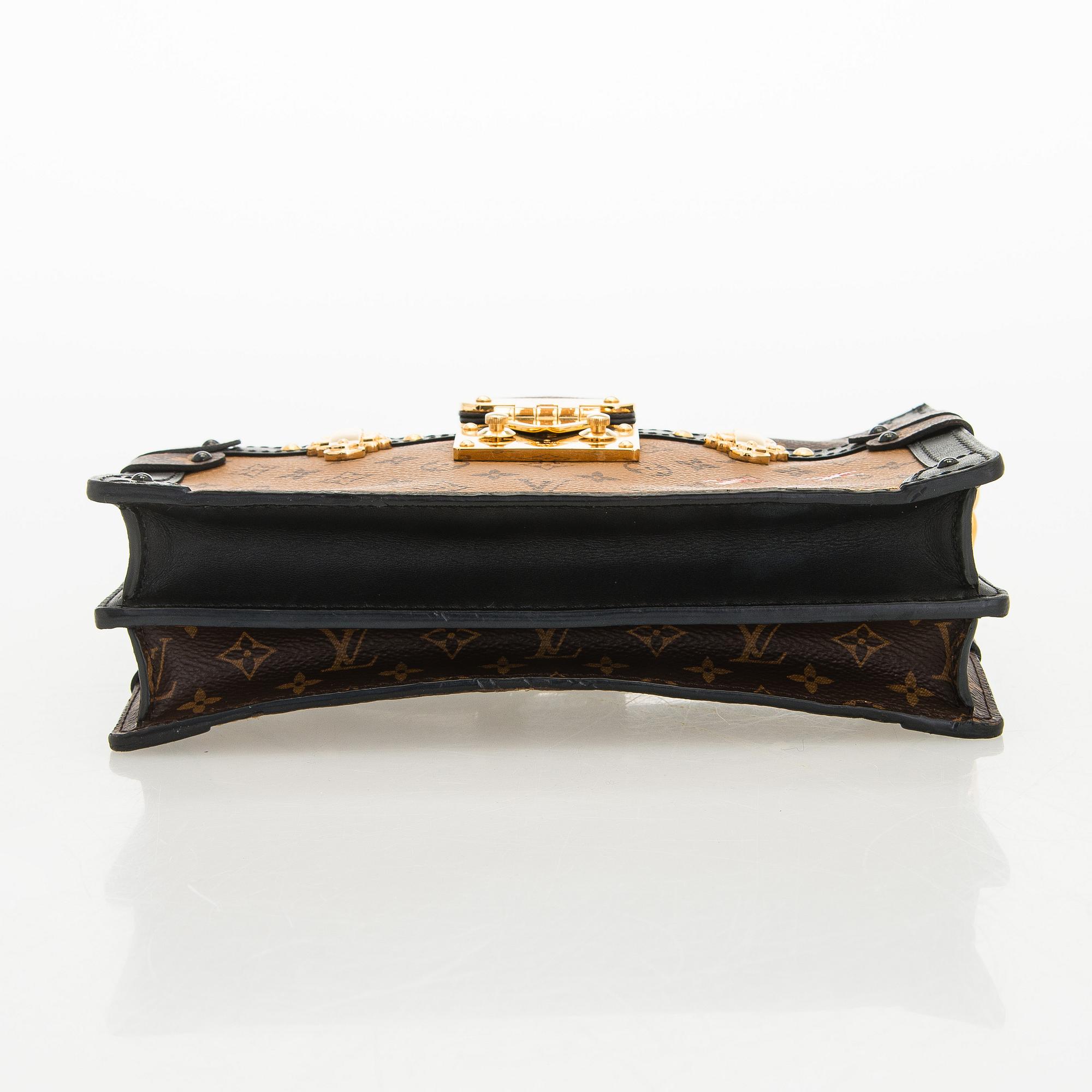 Louis Vuitton, a "Reverse Monogram Trunk Clutch" bag.