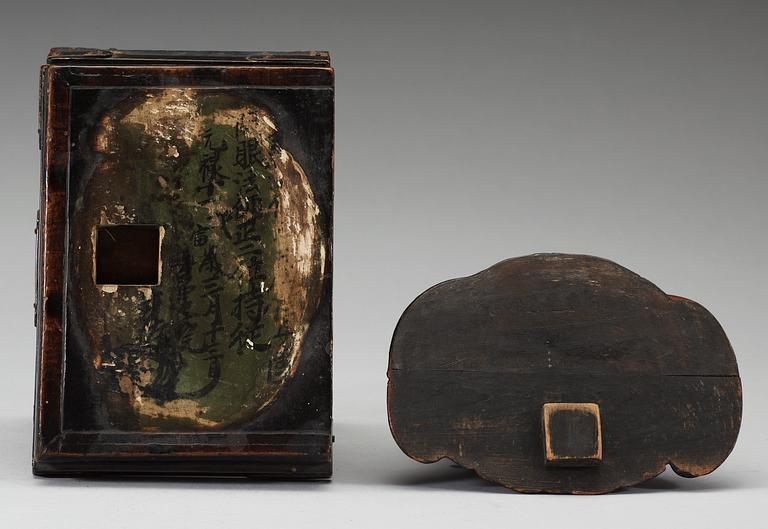 A lacquered wooden Japanese deity on a stand, 19th Century.