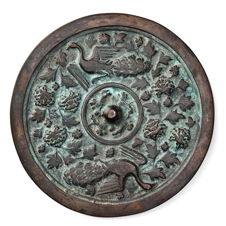 A large bronze mirror, Yuan/Mingdynasty, 13th/14th Century.