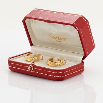 A pair of Cartier "Trinity" earrings in 18K gold set with round brilliant-cut diamonds.