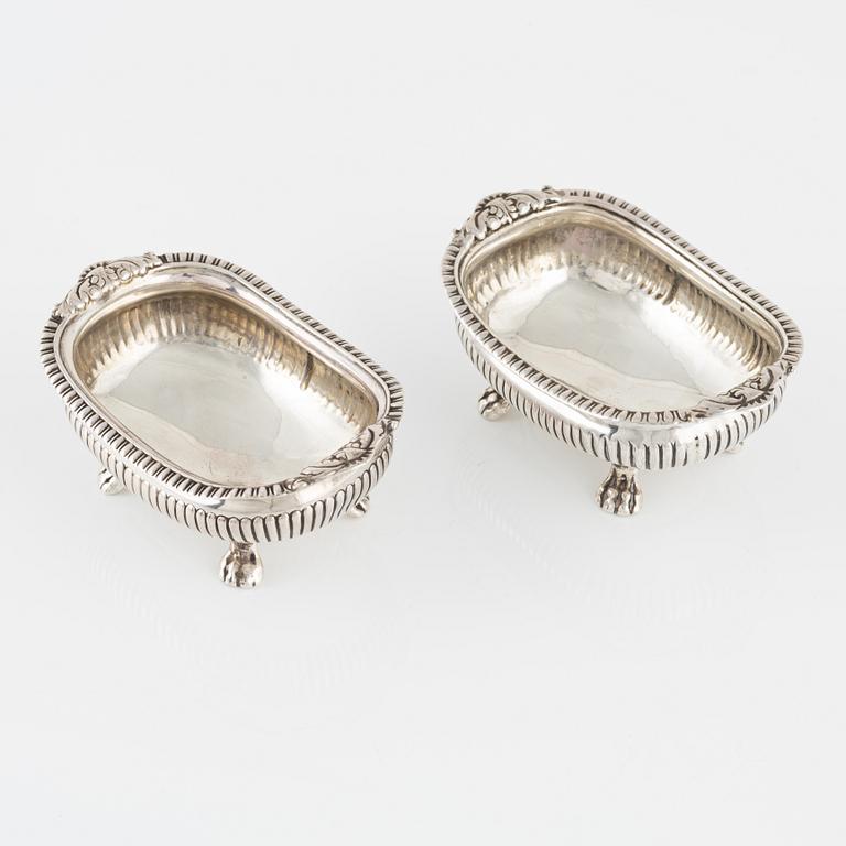 A pair of English Silver Salt Cellars, marks ofJoseph Angell Il 1823 and Samuel Dutton 1826 respectively, London.