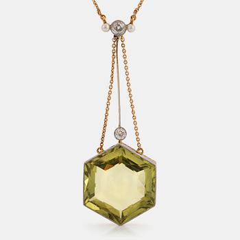 An 18K gold and platinum pendant set with a faceted beryl, old-cut diamonds and pearls.