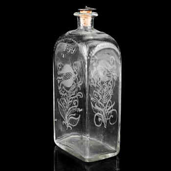 A glass bottle and three vodka glasses, 19th Century.