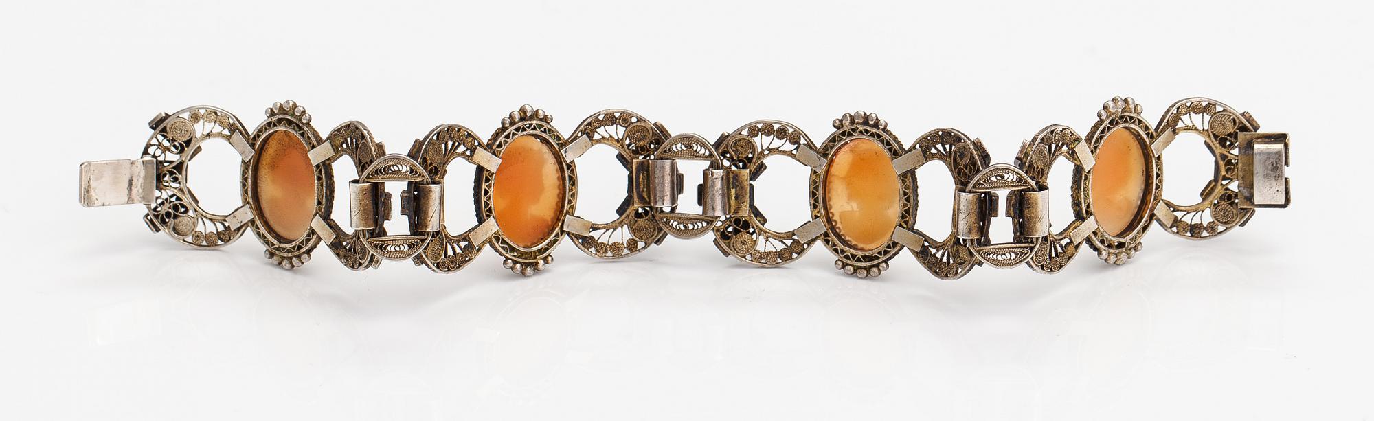 A silver and sea shell cameo bracelet.