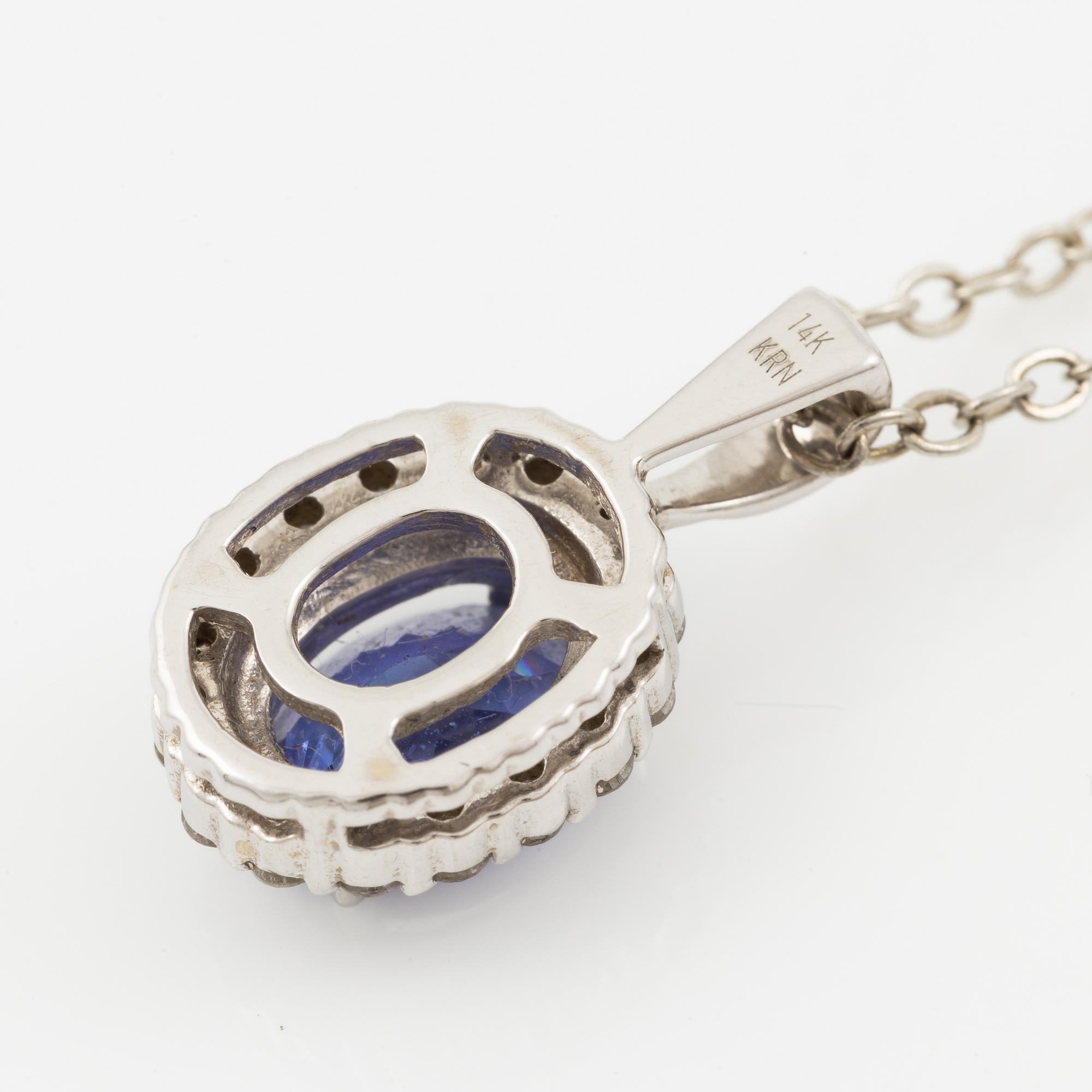 Pendant in 14K white gold set with a faceted tanzanite and round brilliant-cut diamonds.
