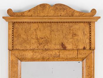 A birch veneered Swedish mirror, late empire, mid 19th Century.