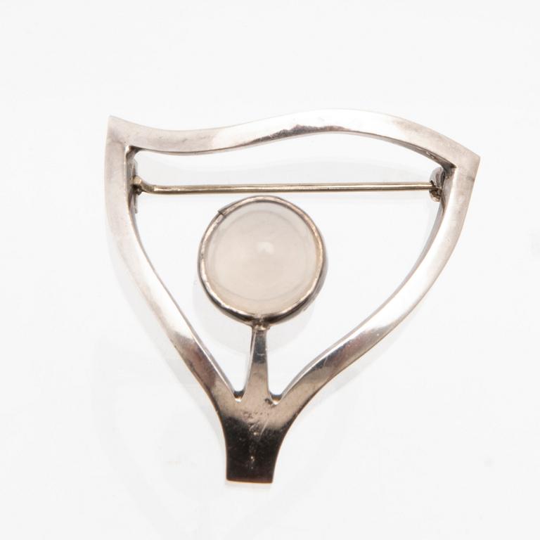 Elon Arenhill, silver brooch with a cabochon-cut moonstone, Malmö 1967.