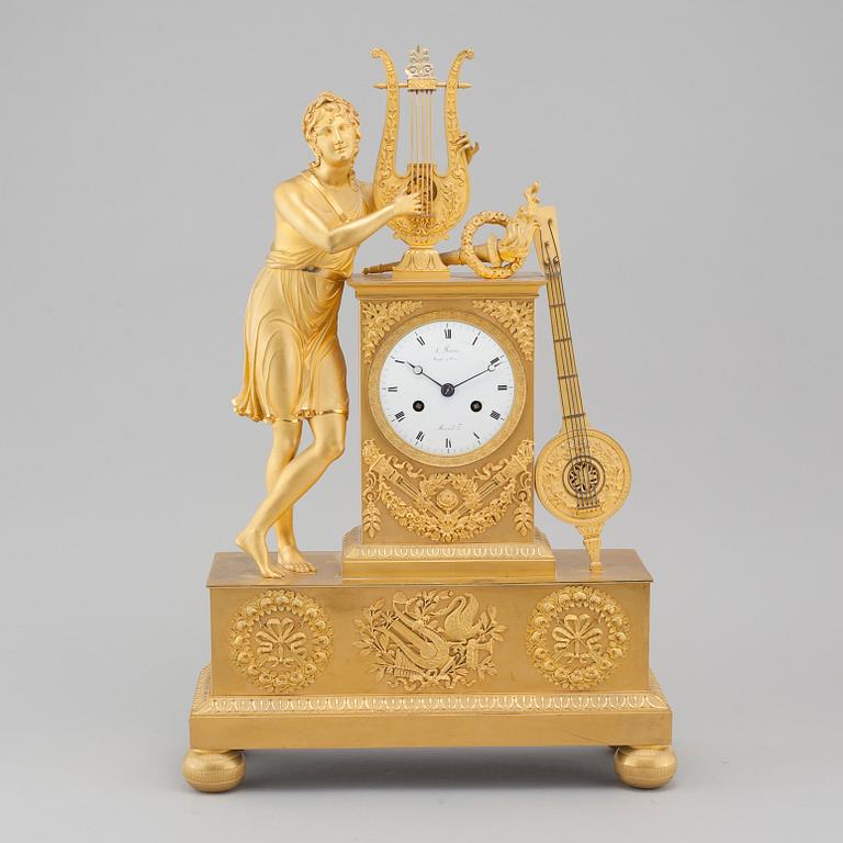 An Empire table clock, dial marked "L Ravrio Bronzier à Paris Mesnil H", fist half of the 20th century.