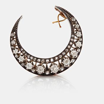 A crescent moon brooch.