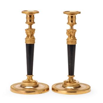 595. A pair of French Empire early 19th century gilt bronze candlesticks.