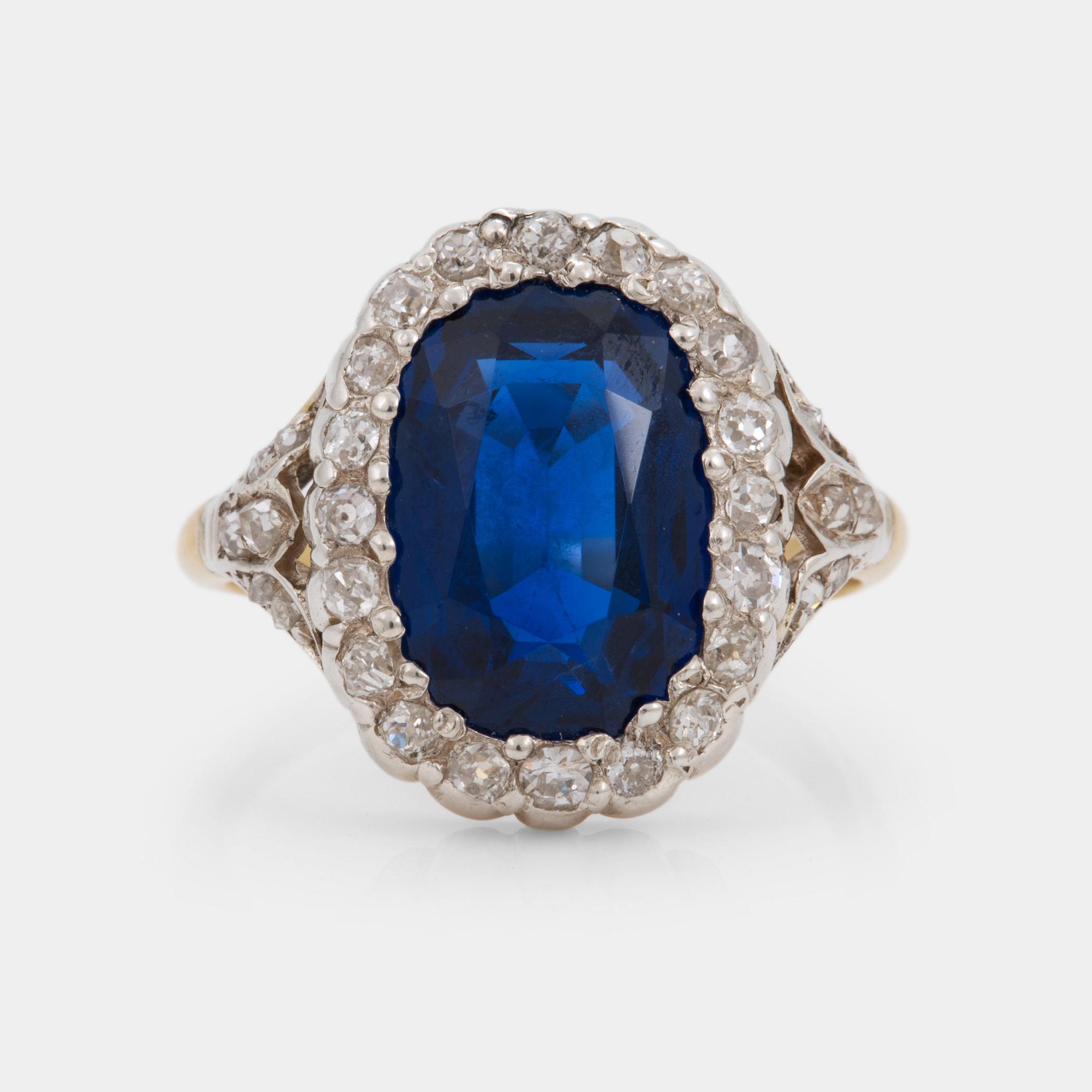 A 7.60 ct unheated sapphire and diamond cluster ring. Certoificate from SSEF.