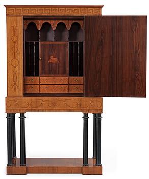 An Oscar Nilsson palisander cabinet on stand with stylized inlays, executed by  Wickman & Nybergs Möblerings- och Snickeriverkstad, Stockholm 1926.