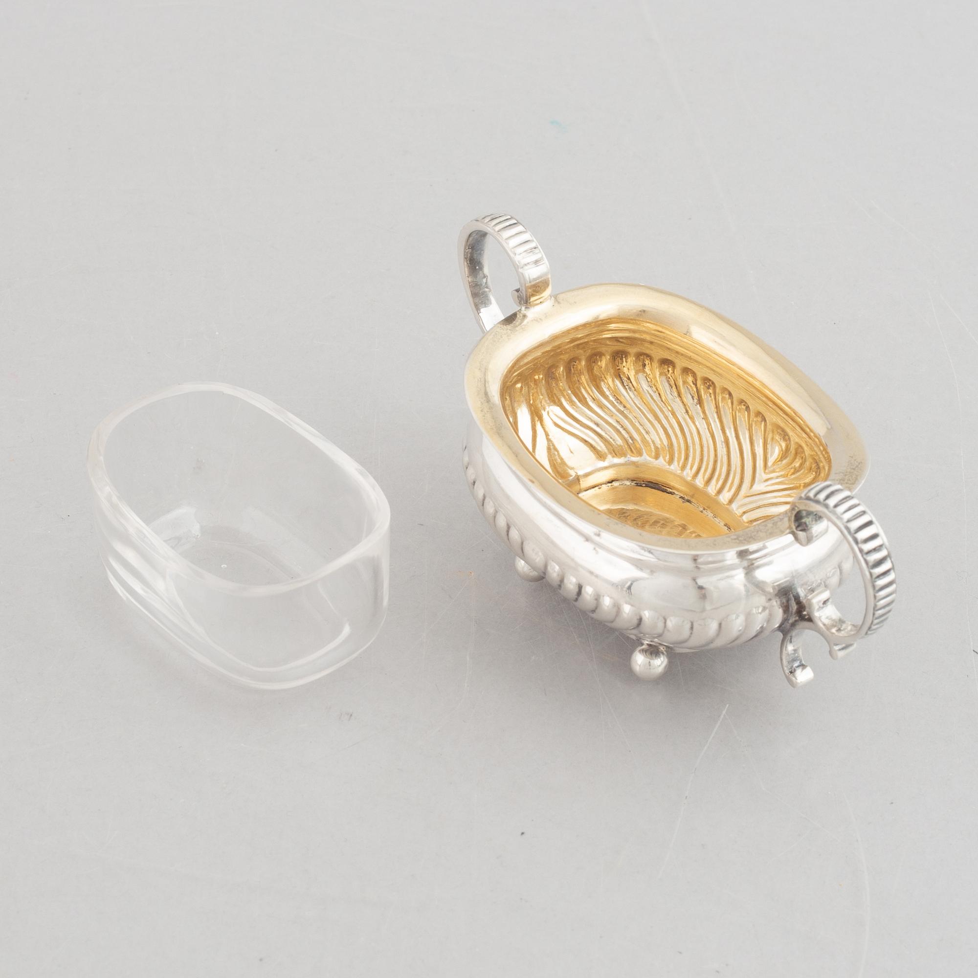 A set of four English silver salt cellars and a toast rack, including Roberts & Belk, Sheffield, England 1898.
