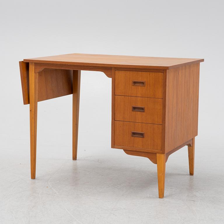 A teak veneered desk, mid 20th Century.