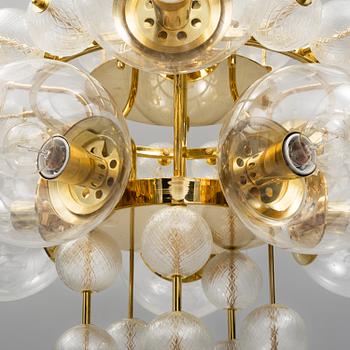 A 1970s brass ceiling light with glass shade. Height ca 144.