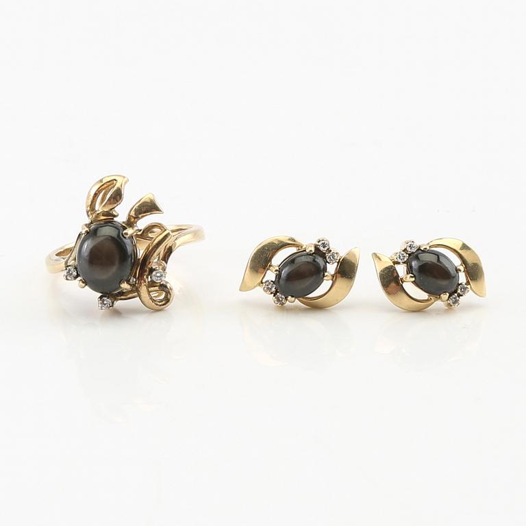 Ring and earrings in 14K gold with round brilliant-cut diamonds and likely natural black star sapphires.