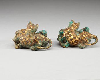 A pair of gilt bronze archaistic weights.