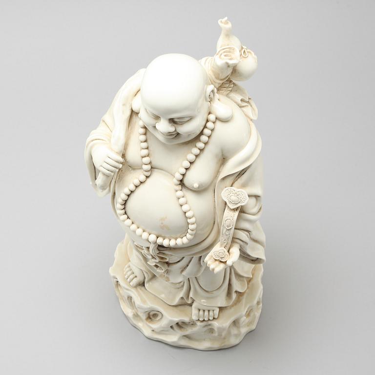 A blanc de Chine porcelian figurine of buddai, 20th Century.