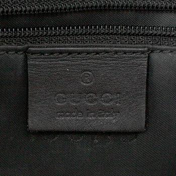 GUCCI, a canvas handbag.