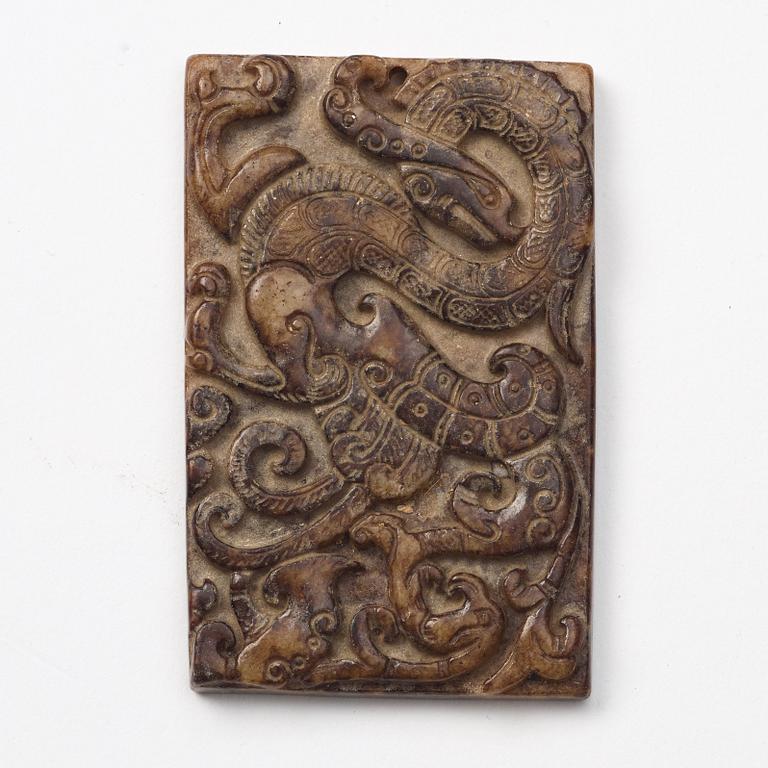 A group of three archaistic Chinese stone bi discs and two pendants.