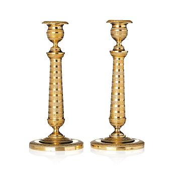 146. A pair of French Empire candlesticks.