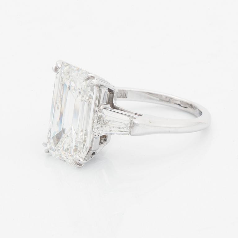 A platinum ring set with an emerald-cut diamond.