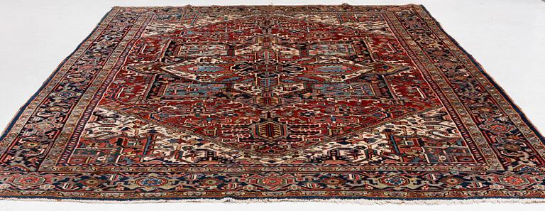 A semi-antique Heris carpet, c. 364 x 299 cm.