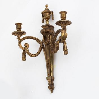 A pair of Louis XVI-style bronze wall sconces, late 19th century.