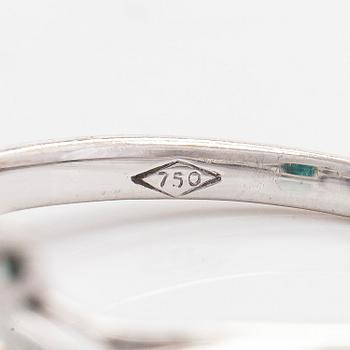 An 18K white gold ring, set with a Zambian emerald and trillion-cut diamonds.