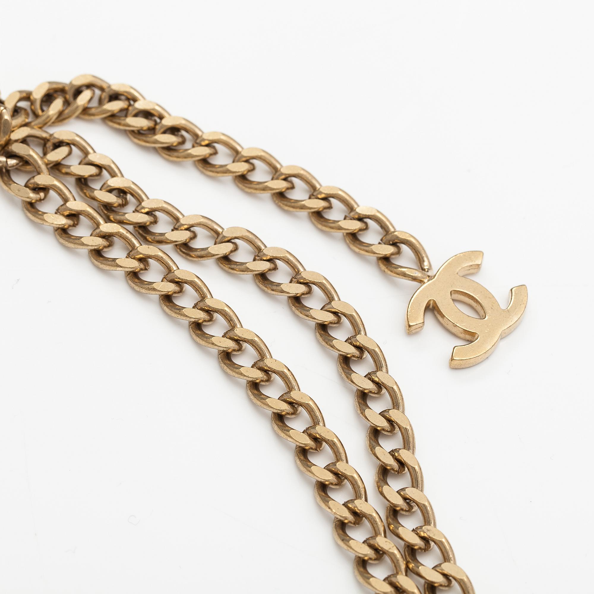 Chanel, A gold coloured metal chain belt with pink stones. Marked "CHANEL 02 CC P MADE IN ITALY".