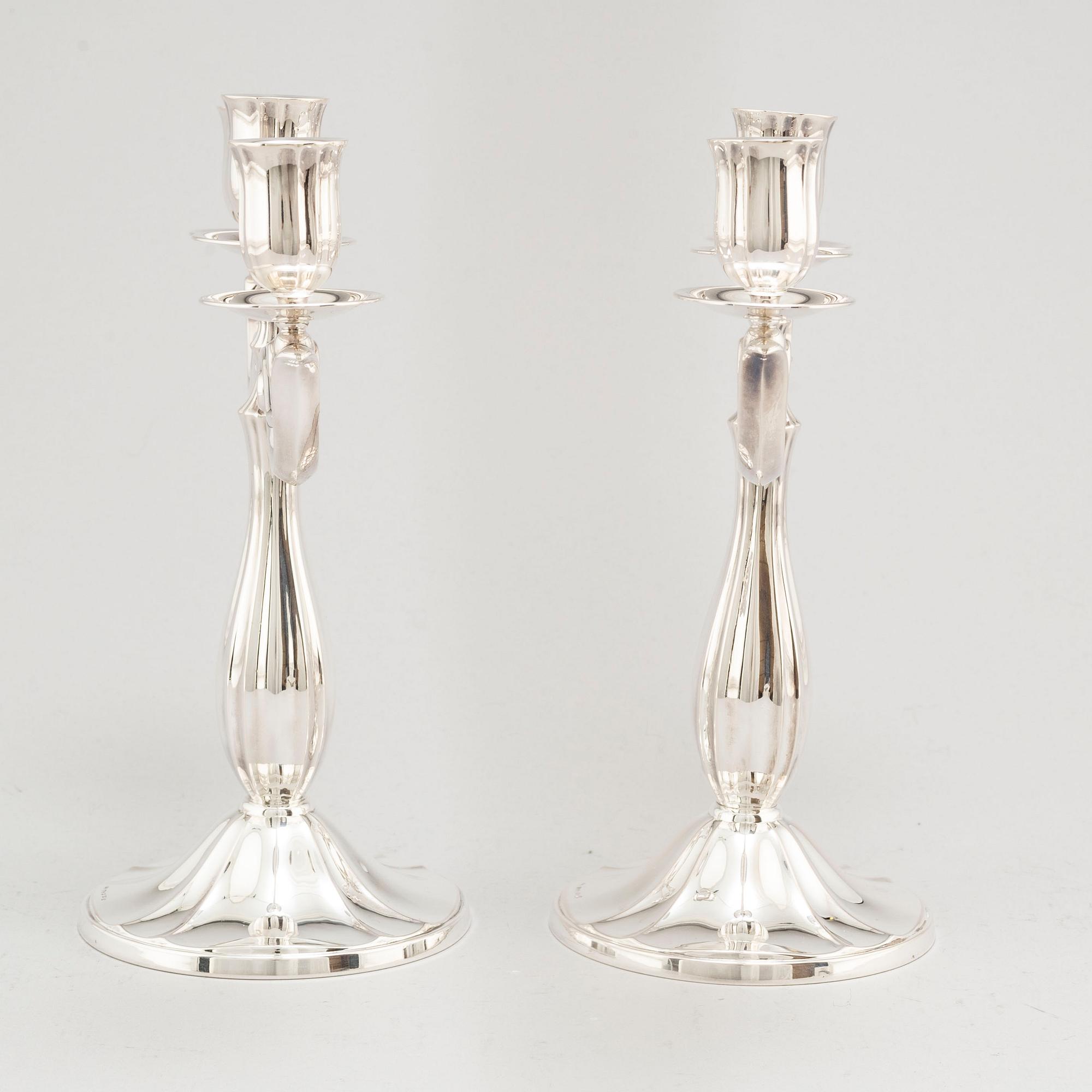 A pair of Swedish silver candelabra, makers mark GAB, Stockholm 1935 and 1938.