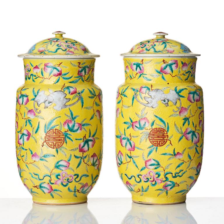 A pair of yellow glazed peach and bat vases with covers, Qing dynasty, 19th Century.